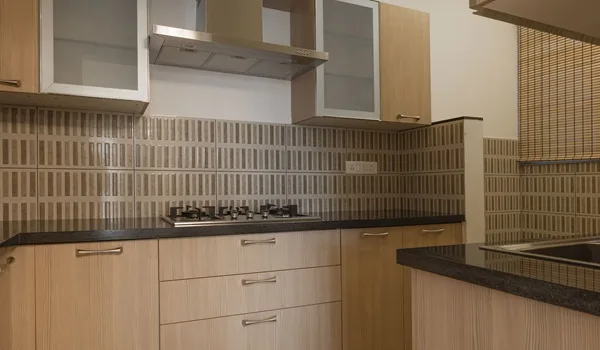 Modular kitchen interior with counter and overhead storage in a Sobha Amara apartment