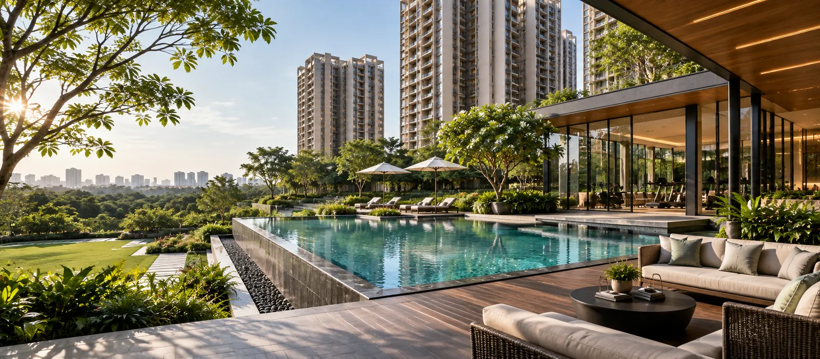 Shaded poolside lounge seating with timber deck and landscaped surroundings at Sobha Amara